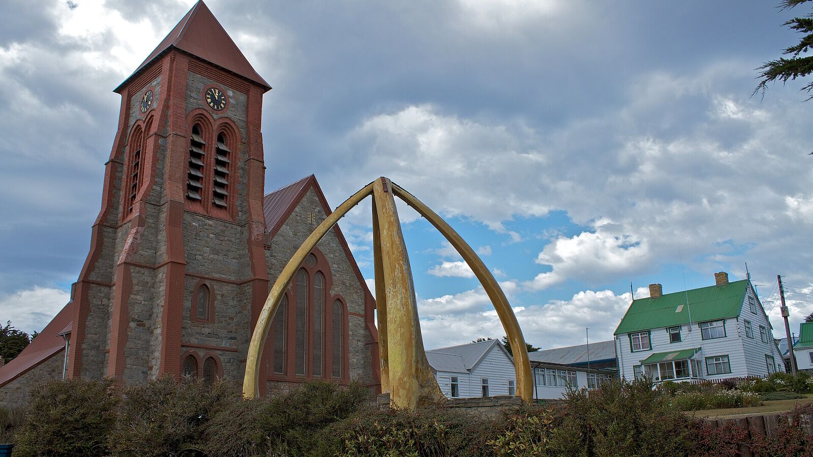 De bakstenen Christ Church Cathedral in Stanley met de boog van walviskaken ervoor